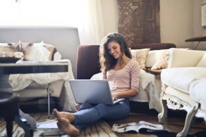 girl on floor on computer social distancing